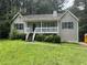 A charming single-Gathering home featuring a quaint front porch and neatly landscaped front yard at 1 Thorntree Pass, Powder Springs, GA 30127