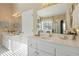 Bright bathroom featuring double vanity sinks with white cabinets and modern fixtures at 10050 Lauren Hall Ct, Alpharetta, GA 30022