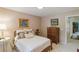 Cozy bedroom with natural light, floral accents and a wooden dresser; perfect for relaxation at 10050 Lauren Hall Ct, Alpharetta, GA 30022