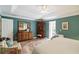 Spacious bedroom with a large dresser, mirror, and ample natural light, creating a serene atmosphere at 10050 Lauren Hall Ct, Alpharetta, GA 30022
