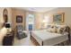 Comfortable bedroom with natural light, a cozy chair, and a restful ambiance for relaxation at 10050 Lauren Hall Ct, Alpharetta, GA 30022