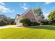 Charming brick home with manicured lawn, mature trees, and attached garage at 10050 Lauren Hall Ct, Alpharetta, GA 30022