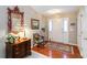 Elegant foyer with hardwood floors, ornate mirror and a traditional area rug at 10050 Lauren Hall Ct, Alpharetta, GA 30022