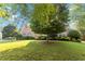 Charming brick home with well-manicured lawn and mature trees, offering great curb appeal at 10050 Lauren Hall Ct, Alpharetta, GA 30022