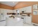 Bright kitchen features white cabinets, center island, and modern appliances at 10050 Lauren Hall Ct, Alpharetta, GA 30022
