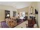 Spacious living room with floral sofas, fireplace, and traditional decor at 10050 Lauren Hall Ct, Alpharetta, GA 30022