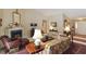 Traditional living room with a fireplace, floral sofas, and decorative rug at 10050 Lauren Hall Ct, Alpharetta, GA 30022