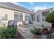 Back patio with a grill and chairs, perfect for relaxing and enjoying the outdoors at 10050 Lauren Hall Ct, Alpharetta, GA 30022