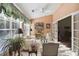 Cozy sunroom with lots of natural light, plantation shutters, and comfortable seating at 10050 Lauren Hall Ct, Alpharetta, GA 30022