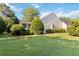 Side view showing lush lawn and beautiful landscaping of the home at 10050 Lauren Hall Ct, Alpharetta, GA 30022