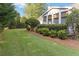 Side view showing a healthy green lawn and beautiful landscaping at 10050 Lauren Hall Ct, Alpharetta, GA 30022