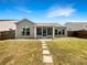 Lovely backyard with screened in porch and stepping stone path at 2838 Menton Rd, Powder Springs, GA 30127