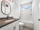 Well-lit bathroom with a single sink vanity, shower-tub combination, and modern fixtures at 2838 Menton Rd, Powder Springs, GA 30127