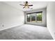 Spacious bedroom with large windows, carpeted floors, and a modern ceiling fan at 2838 Menton Rd, Powder Springs, GA 30127