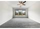 Bright bedroom with ceiling fan, carpet floors, and large windows overlooking backyard at 2838 Menton Rd, Powder Springs, GA 30127