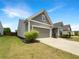 Charming home featuring gray siding, a two-car garage, and manicured landscaping at 2838 Menton Rd, Powder Springs, GA 30127