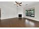 Bright living room with hardwood floors, fireplace, and large windows overlooking backyard at 2838 Menton Rd, Powder Springs, GA 30127