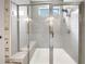 Modern bathroom featuring a glass-enclosed shower with a built-in bench and sleek fixtures at 2838 Menton Rd, Powder Springs, GA 30127