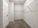 Walk-in closet with ample shelving and carpeted flooring, perfect for organization at 2838 Menton Rd, Powder Springs, GA 30127