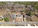 An aerial view of three residential homes with mature trees in their yards and a wooded area in the background at 4558 Ryan Rd, Conley, GA 30288