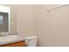 Well-lit bathroom with a granite countertop vanity and standard toilet at 5942 Idlewood Pl, Lithonia, GA 30038