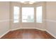 Bright dining nook featuring three windows, brown flooring, and neutral paint at 5942 Idlewood Pl, Lithonia, GA 30038