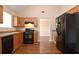 Well-equipped kitchen with black appliances, oak cabinets, and an open layout to the dining area at 5942 Idlewood Pl, Lithonia, GA 30038
