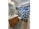 Cozy bathroom featuring a vanity with wood cabinets and a shower with a floral curtain at 1447 Evanston, Marietta, GA 30062
