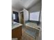 Bathroom featuring a tub, walk-in shower, and a large window at 1447 Evanston, Marietta, GA 30062