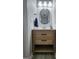Small bathroom with wood vanity, modern mirror and lighting at 1447 Evanston, Marietta, GA 30062