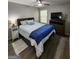 Comfortable bedroom with ceiling fan, dresser, and wooden floors; ideal for relaxation at 1447 Evanston, Marietta, GA 30062