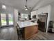 Bright kitchen with white cabinets, stainless steel appliances, and an island with seating at 1447 Evanston, Marietta, GA 30062