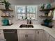 Modern kitchen with stainless steel sink, garden window, and floating shelves above the backsplash at 1447 Evanston, Marietta, GA 30062