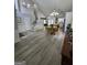 Open concept living area with wood floors, a dining table and an island in the kitchen at 1447 Evanston, Marietta, GA 30062