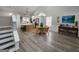 Open-concept living room with an island in the kitchen and wood floors and a dining table at 1447 Evanston, Marietta, GA 30062