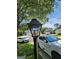 Neighborhood street view with a light pole and houses and a car is parked in the driveway at 1447 Evanston, Marietta, GA 30062
