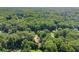 Scenic aerial shot showing a home nestled in a lush, wooded setting at 15 Miners Pt Se, Acworth, GA 30102