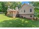 A view of the home from the spacious backyard, featuring a large wooden deck at 15 Miners Pt Se, Acworth, GA 30102