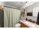 Bathroom featuring a shower with a curtain, stylish vanity, and decorative accents at 15 Miners Pt Se, Acworth, GA 30102