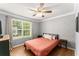 Bedroom with neutral paint, bedside tables, and large window providing ample natural light at 15 Miners Pt Se, Acworth, GA 30102