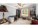 Bright bedroom features a ceiling fan, desk, and large window with natural light at 15 Miners Pt Se, Acworth, GA 30102