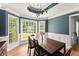 Charming dining room with wainscoting, tray ceiling, large windows, and a wooden table at 15 Miners Pt Se, Acworth, GA 30102