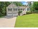 Charming split-level home with a well-manicured lawn, two-car garage, and inviting front porch at 15 Miners Pt Se, Acworth, GA 30102