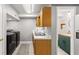 Laundry room with cabinetry and stainless steel appliances and an adjacent bathroom at 15 Miners Pt Se, Acworth, GA 30102