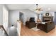 Bright living room featuring vaulted ceilings, a brick fireplace, and hardwood floors at 15 Miners Pt Se, Acworth, GA 30102