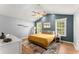 Bedroom featuring a ceiling fan, bedside tables, and large window with natural light at 15 Miners Pt Se, Acworth, GA 30102