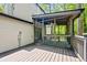 Screened-in porch with ceiling fan, dining set, and wooded view, perfect for outdoor relaxation at 2136 N Landing Way, Marietta, GA 30066