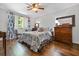 Cozy bedroom with wood flooring, bright window, ceiling fan, and dresser at 2136 N Landing Way, Marietta, GA 30066