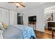 Bright bedroom featuring a ceiling fan, hardwood flooring, and closet doors at 2136 N Landing Way, Marietta, GA 30066