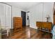Simple bedroom with wood floors, a dresser, a chair, and a black closet door at 2136 N Landing Way, Marietta, GA 30066